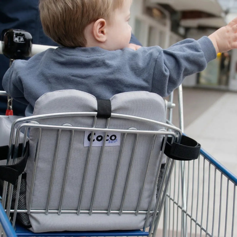 Rear view of Cocoseat shopping cart insert showing padded back support and brand label
