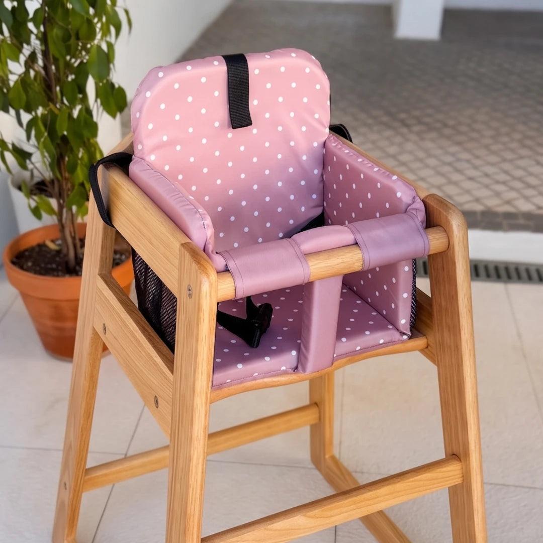 Coco Comfort Seat in pink polka dot pattern, installed inside a wooden high chair