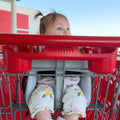 Baby seated in Cocoseat shopping cart insert, low angle view showing padded support